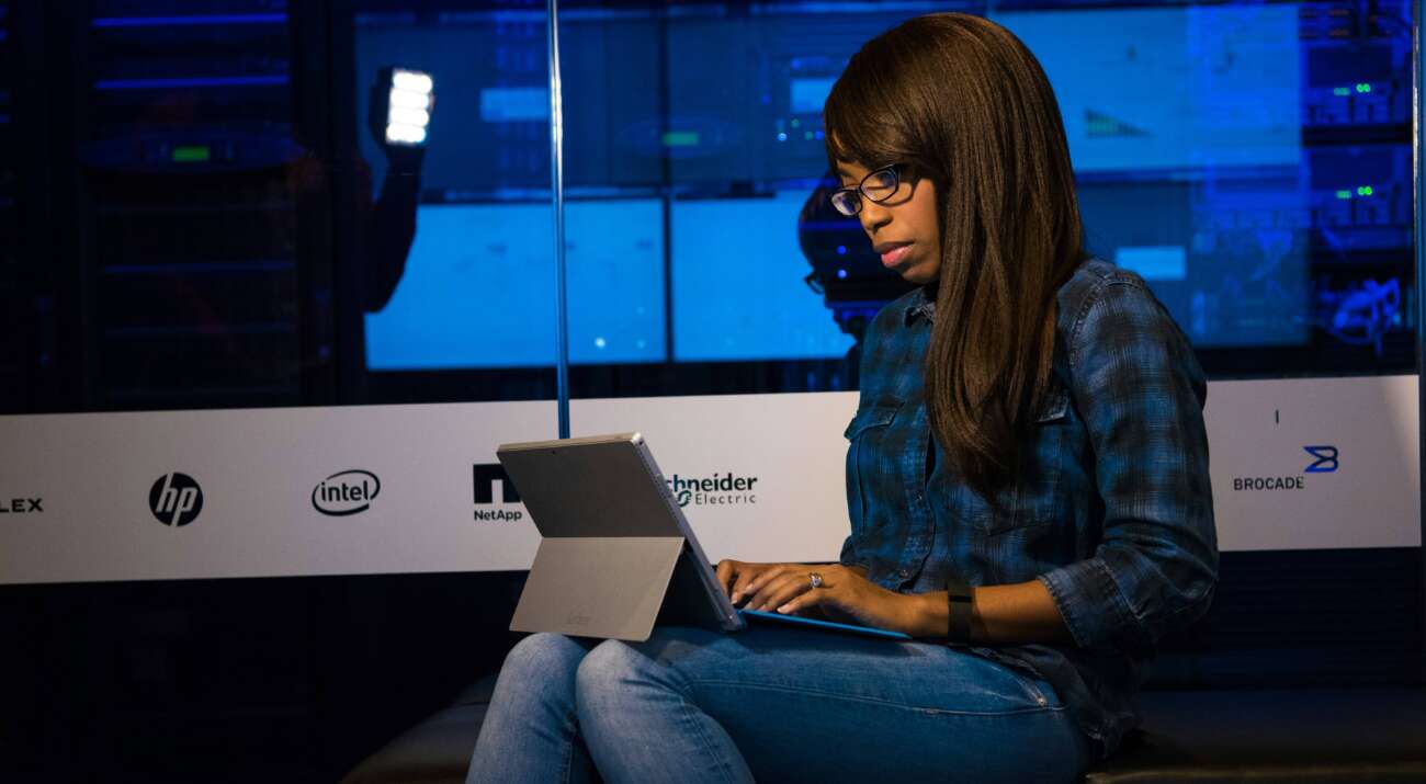 woman typing on a laptop working out how to save on her cloud spend on aws