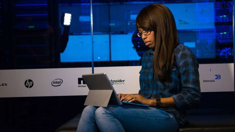 woman typing on a laptop working out how to save on her cloud spend on aws